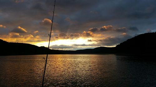 Scenic view of lake against cloudy sky