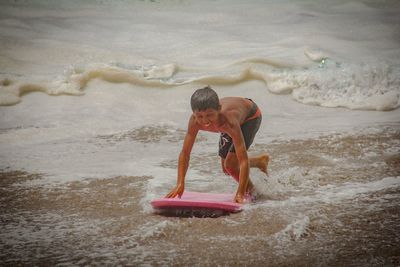 High angle view of shirtless man in sea