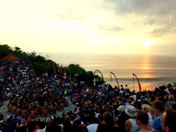 Group of people on beach during sunset