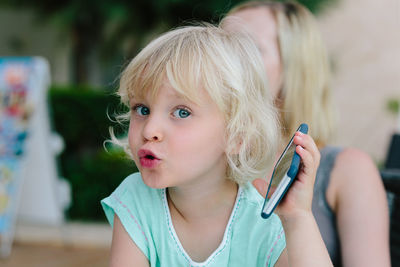 Close-up of girl using mobile phone