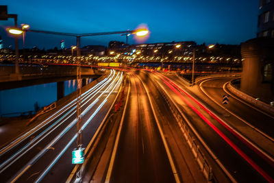 High angle view of light trails on highway at night