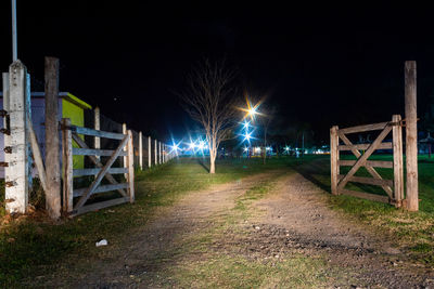 Illuminated street lights on footpath at night