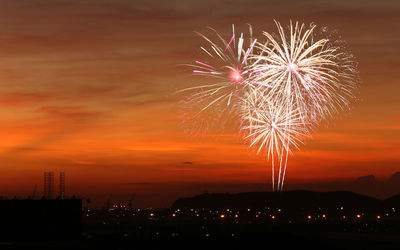 Firework display against sky at night