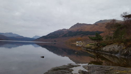 Scenic view of lake and mountains against sky