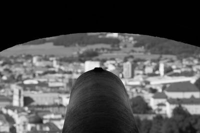 Close-up of hand against cityscape