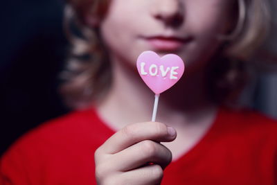 Close-up of woman holding heart shape balloon