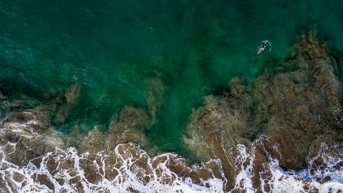 Aerial view of woman swimming in sea