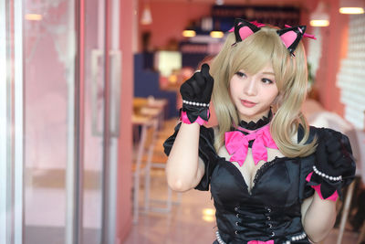 Young woman wearing costume at home