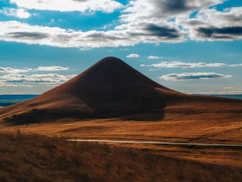 Scenic view of arid landscape against sky