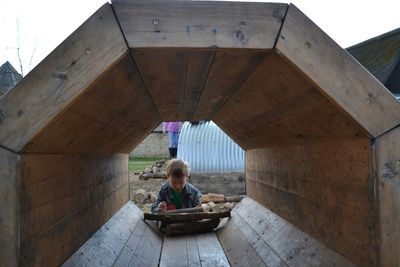 Boy sitting on bridge