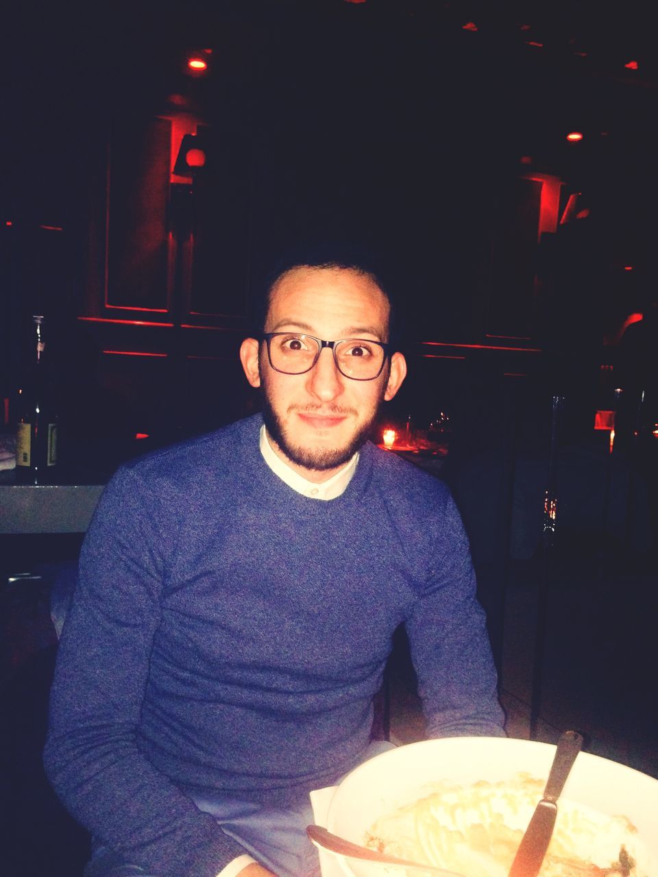 PORTRAIT OF MID ADULT MAN IN ILLUMINATED KITCHEN