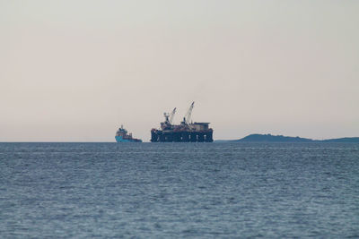 Offshore platform in sea against sky