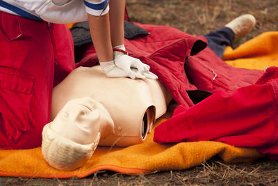 Paramedic practicing cpr on mannequin