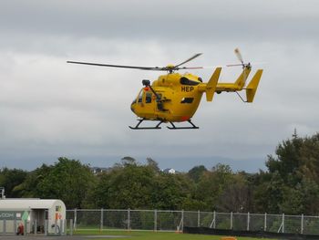 Low angle view of airplane flying against sky