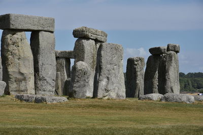 Stone structure on field against sky