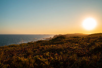 Scenic view of sea against clear sky during sunset