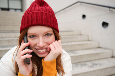 Portrait of young woman using mobile phone