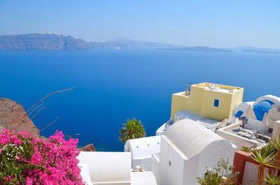 High angle view of houses at santorini by blue sea