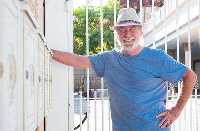 Portrait of smiling senior man standing outdoors