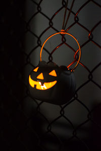 Close-up of illuminated chainlink fence at night
