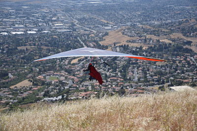 Rear view of person hang-gliding in mid-air