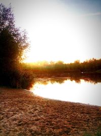 Scenic view of lake against sky during sunset