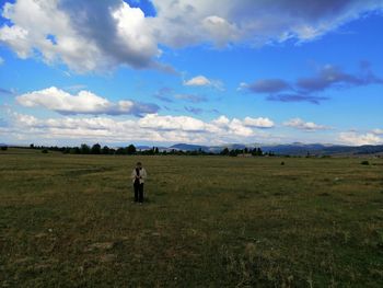 Man standing on field against sky