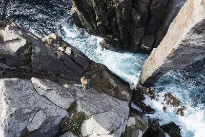 High angle view of waterfall amidst rocks