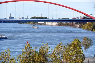 Bridge over river in city against sky
