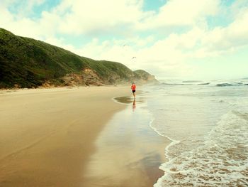 People on beach against sky