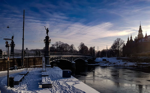 Snow covered city against sky