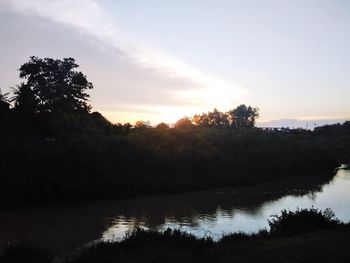 Scenic view of lake against sky at sunset