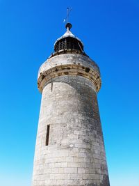 Low angle view of lighthouse against clear blue sky