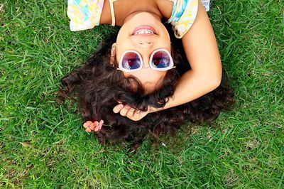High angle view of woman lying down on grass