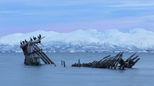 Scenic view of snowcapped mountains against sky during winter