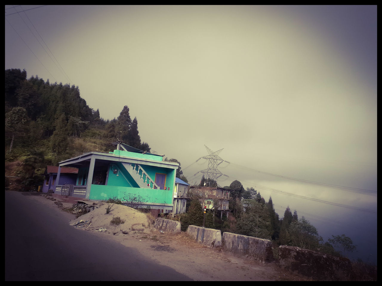 ROAD BY BUILDINGS AGAINST SKY