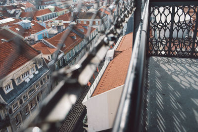 High angle view of buildings in city seen through fence