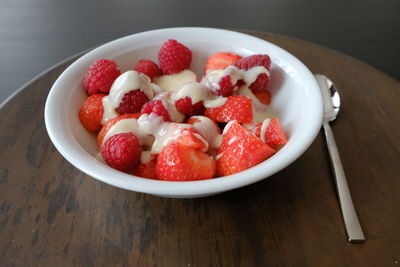 High angle view of strawberries in bowl on table