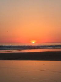 Scenic view of beach against sky during sunset