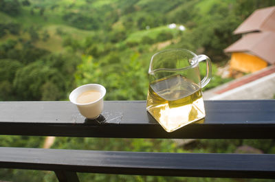 High angle view of tea and pot on railing