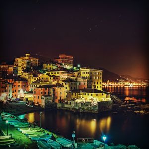 Illuminated genoa cityscape against sky at night