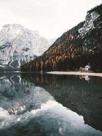 Scenic view of lake by mountains against sky in forest