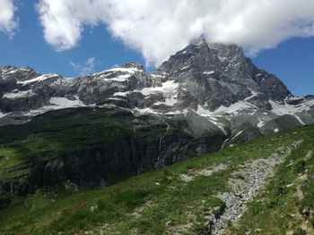 Scenic view of mountains against cloudy sky