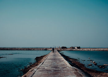 Pier over sea against clear sky