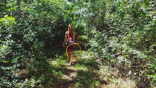 Full length of young woman in forest