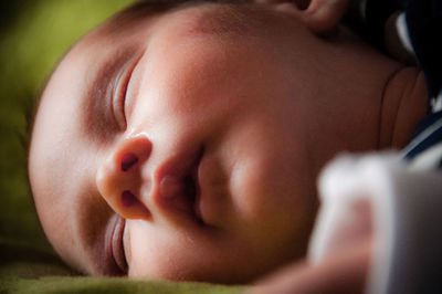 Close-up of newborn baby sleeping at home
