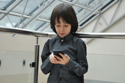 Caucasian schoolerboy using modern technology and video chatting with friends mobile in cafe