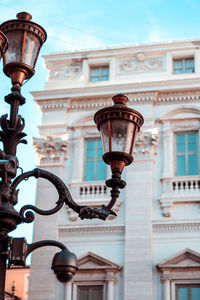 Low angle view of street light against building