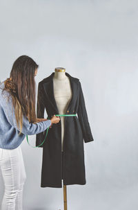 Rear view of woman standing against sky