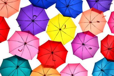 Low angle view of multi colored umbrellas hanging on clothesline